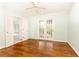 Bright bedroom with hardwood floors, ceiling fan, and access to bathroom and backyard through french doors at 70 Mount Paran Ne Rd, Atlanta, GA 30342