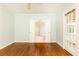 Sunlit bedroom with hardwood floors, ceiling fan, and access to bathroom and backyard through french doors at 70 Mount Paran Ne Rd, Atlanta, GA 30342