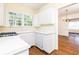 Kitchen featuring wood floors, white cabinets, and a corner sink under the window at 70 Mount Paran Ne Rd, Atlanta, GA 30342