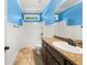 Bathroom featuring a tub, granite countertop, and stylish fixtures with a calming blue accent wall at 90 Alcovy Reserve Way, Covington, GA 30014