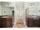 Dual sink vanities in bathroom, featuring granite countertops and decorative mirrors at 90 Alcovy Reserve Way, Covington, GA 30014