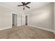 Bedroom with ensuite bathroom, neutral walls, carpet, and ceiling fan at 90 Alcovy Reserve Way, Covington, GA 30014