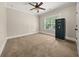Spacious bedroom with a ceiling fan and natural light, offering a comfortable and inviting atmosphere at 90 Alcovy Reserve Way, Covington, GA 30014