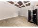 Spacious bedroom with coffered ceiling, neutral walls, and plush carpeting at 90 Alcovy Reserve Way, Covington, GA 30014