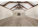 Open-concept living room with vaulted ceilings, exposed beams, and stone fireplace at 90 Alcovy Reserve Way, Covington, GA 30014