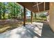 Covered back patio featuring wooden support beams and overlooks a lush, green backyard at 90 Alcovy Reserve Way, Covington, GA 30014