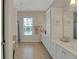 Bathroom with white cabinets, dual sinks, and a tile floor at 125 Rabbits Run, Fayetteville, GA 30215