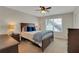 Comfortable bedroom with a large bed, wood furniture, and natural light from a window at 125 Rabbits Run, Fayetteville, GA 30215