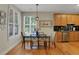 Bright eat-in kitchen area with a modern table, pendant light, and hardwood flooring at 125 Rabbits Run, Fayetteville, GA 30215