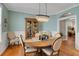 Elegant dining room with a chandelier, hardwood floors, and decorative wall trim at 125 Rabbits Run, Fayetteville, GA 30215