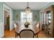 Charming dining room with hardwood floors, decorative lighting, and elegant furniture at 125 Rabbits Run, Fayetteville, GA 30215