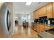 An eat-in kitchen featuring light wood cabinets, stainless appliances, and dark countertops at 125 Rabbits Run, Fayetteville, GA 30215