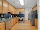 Bright kitchen with wood cabinets, stainless steel appliances, and dark countertops at 125 Rabbits Run, Fayetteville, GA 30215