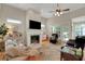 Cozy living room with a fireplace, plush seating, and lots of natural light at 125 Rabbits Run, Fayetteville, GA 30215