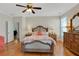 Spacious main bedroom with hardwood floors, ceiling fan, and a large window at 125 Rabbits Run, Fayetteville, GA 30215