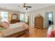 Spacious main bedroom with hardwood floors, ceiling fan, and large windows at 125 Rabbits Run, Fayetteville, GA 30215