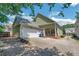 Rear view of home with a two-car garage, covered patio, and landscaped yard at 125 Rabbits Run, Fayetteville, GA 30215