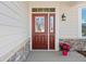 Inviting red front door with sidelight, stone accents, and a charming flower pot at 41 Balsam Dr, Dallas, GA 30157