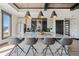 Contemporary kitchen island with stone countertop, seating, modern lighting, and stainless steel appliances at 41 Balsam Dr, Dallas, GA 30157