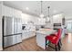 Bright kitchen with stainless steel appliances, granite countertops, white cabinets, subway tile backsplash and pendant lighting at 41 Balsam Dr, Dallas, GA 30157