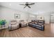 Bright living room featuring a leather sofa, recliner chairs, ceiling fan, and an open floor plan at 41 Balsam Dr, Dallas, GA 30157