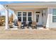 Covered back patio with comfortable seating, providing an ideal outdoor living space with plenty of light at 41 Balsam Dr, Dallas, GA 30157