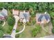 Aerial view of a red brick home with mature trees and pristine landscaping at 470 Manor Oak Se Ln, Marietta, GA 30067