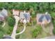 Beautiful home aerial view featuring a well maintained lawn, manicured bushes and circular driveway at 470 Manor Oak Se Ln, Marietta, GA 30067