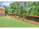 Large backyard deck with brown railing overlooking a treed backyard under a blue sky at 470 Manor Oak Se Ln, Marietta, GA 30067
