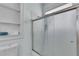 Bathroom featuring a shower with sliding glass doors and built-in shelves at 470 Manor Oak Se Ln, Marietta, GA 30067