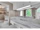 Bathroom showcases a vanity with a marble countertop, an arched window, and a large mirror at 470 Manor Oak Se Ln, Marietta, GA 30067