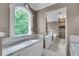 Bathroom featuring a marble countertop, large window, and mirror at 470 Manor Oak Se Ln, Marietta, GA 30067