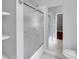 Bathroom showcasing a bathtub with glass doors and a large mirror on the wall at 470 Manor Oak Se Ln, Marietta, GA 30067
