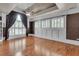 Primary bedroom featuring hardwood floors, coffered ceiling, custom shutters, and large windows at 470 Manor Oak Se Ln, Marietta, GA 30067