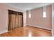 Bedroom with hardwood floors, peach walls, and dark curtains covering the window at 470 Manor Oak Se Ln, Marietta, GA 30067