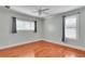 Bright bedroom with hardwood floors, ceiling fan, and two windows with blinds at 470 Manor Oak Se Ln, Marietta, GA 30067