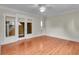 Airy bedroom featuring hardwood floors, a ceiling fan, and glass doors for natural light and seamless access at 470 Manor Oak Se Ln, Marietta, GA 30067