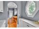 Dining area with a large, uniquely-shaped window and neutral tones at 470 Manor Oak Se Ln, Marietta, GA 30067