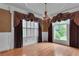 Formal dining room features hardwood floors, elegant chandelier, and large windows at 470 Manor Oak Se Ln, Marietta, GA 30067