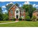 Beautiful two-story brick home featuring a manicured lawn, lovely landscaping and a classic architectural design at 470 Manor Oak Se Ln, Marietta, GA 30067