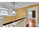 Hallway with hardwood floors, white trim, and a decorative light fixture at 470 Manor Oak Se Ln, Marietta, GA 30067