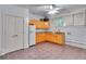 Kitchenette featuring wood cabinets, granite counters, tile floors, and a ceiling fan at 470 Manor Oak Se Ln, Marietta, GA 30067
