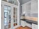 Home office with a built-in desk, cabinetry, and French doors leading to the main hallway at 470 Manor Oak Se Ln, Marietta, GA 30067