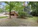 Back of home with a large patio, basketball court, mature trees and lush lawn at 635 Wilson Nw Rd, Atlanta, GA 30318