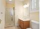 Cozy bathroom featuring a glass shower, wooden cabinets and a window that provides natural light at 635 Wilson Nw Rd, Atlanta, GA 30318