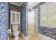Bathroom features a shower, toilet, cabinet, and window, all adorned with zebra print wallpaper at 635 Wilson Nw Rd, Atlanta, GA 30318