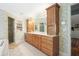 The bathroom has lots of wood cabinets with a walk in shower, and neutral colored tile floors at 635 Wilson Nw Rd, Atlanta, GA 30318
