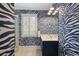 The bathroom features a unique zebra print design, a shower, and a window with plantation shutters at 635 Wilson Nw Rd, Atlanta, GA 30318