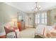Inviting bedroom featuring neutral decor, a decorative chandelier, and large windows at 635 Wilson Nw Rd, Atlanta, GA 30318