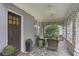 Inviting front porch with stone flooring, seating area, and ceiling fans at 635 Wilson Nw Rd, Atlanta, GA 30318
